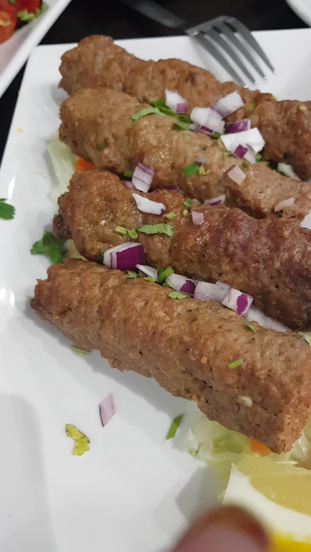 Kebabs served with red onion, coriander and lemon at Himalayan Club